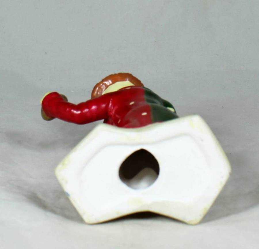 Clown figurine holding a pie