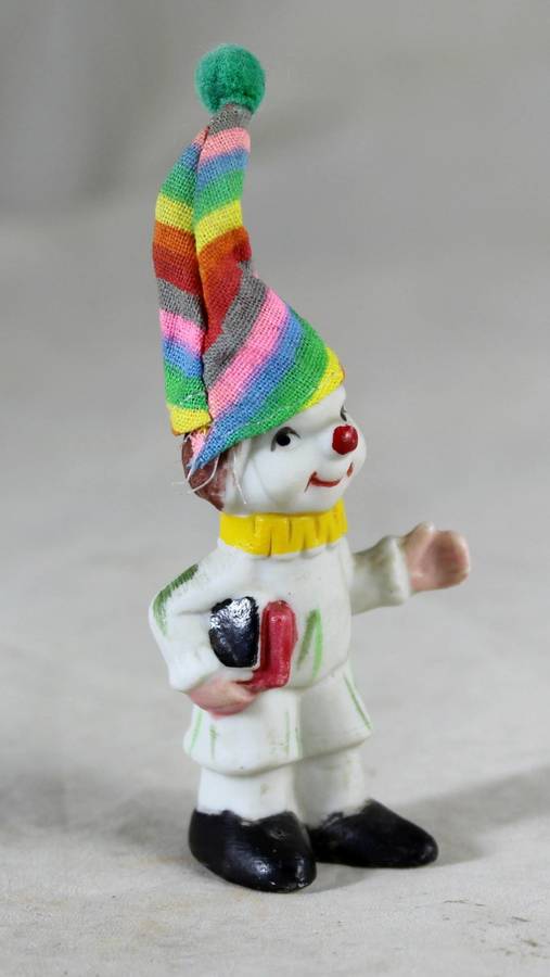 Miniature clown holding books