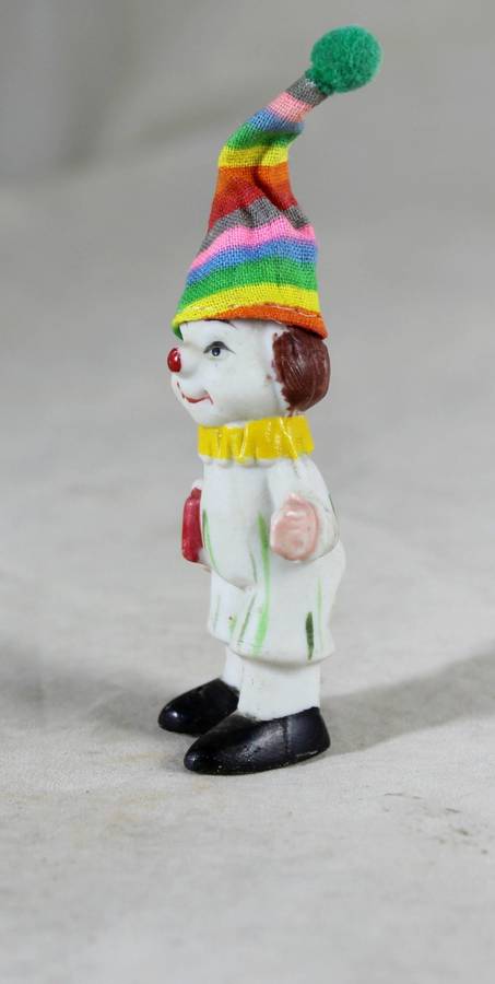 Miniature clown holding books