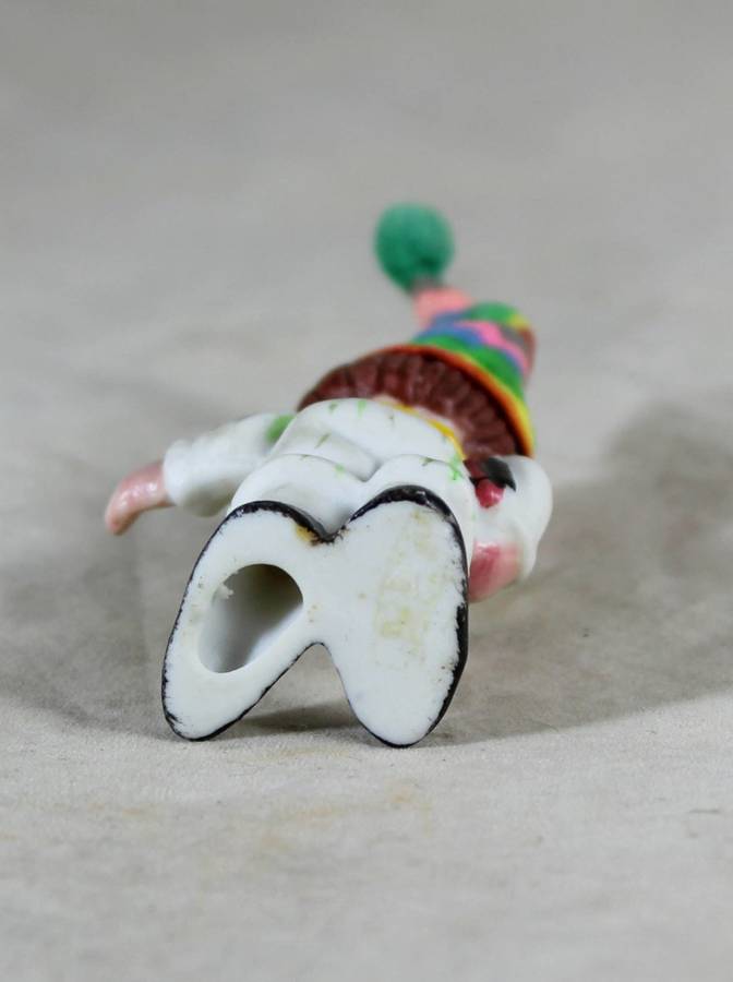 Miniature clown holding books