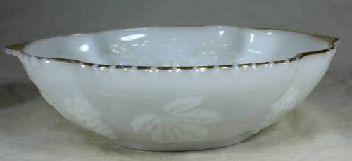 Milk glass bowl with grapes and a gold rim