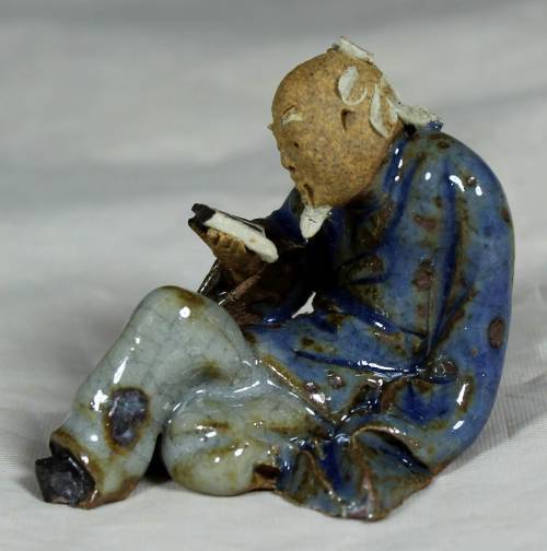 Mud Men - Seated man reading