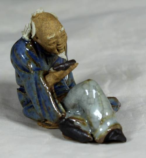 Mud Men - Seated man reading