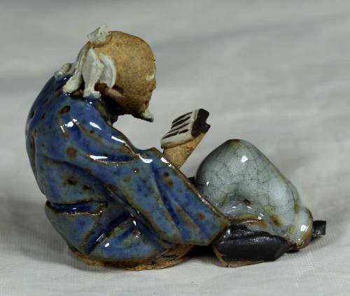 Mud Men - Seated man reading