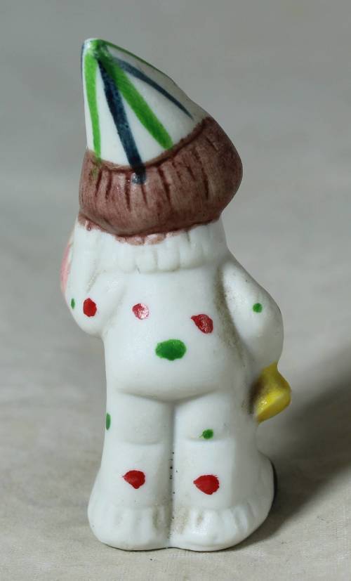 Miniature clown holding a large clock