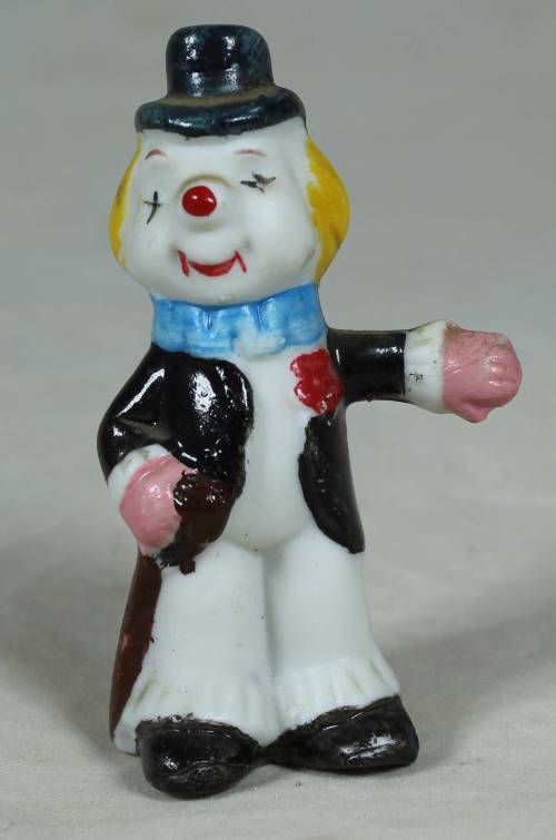 Miniature clown holding a cane