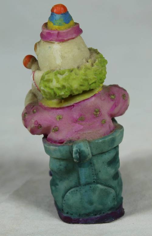 Miniature clown sitting in a shoe