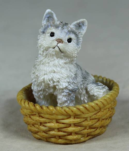 Miniature kitten in a basket