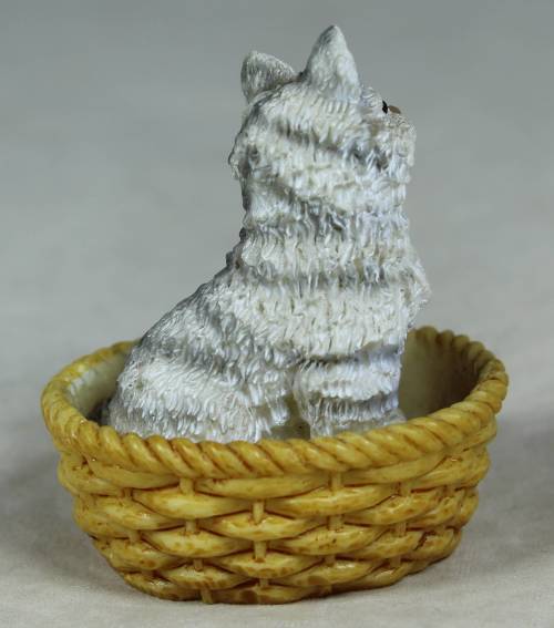 Miniature kitten in a basket