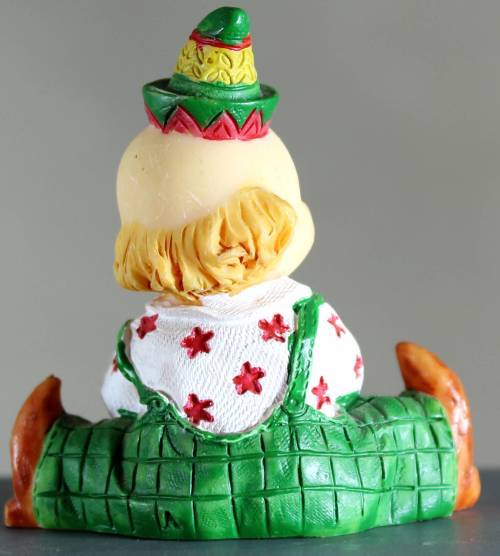 Small clown figurine baby with a ball