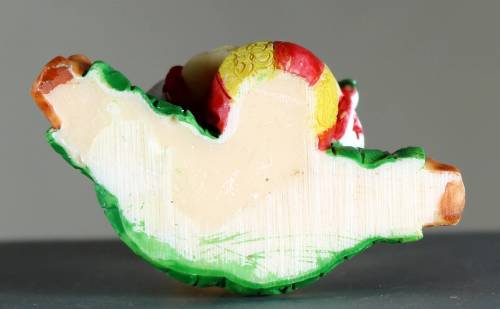 Small clown figurine baby with a ball