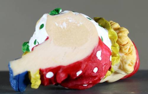 Small clown figurine kid putting on his shoe