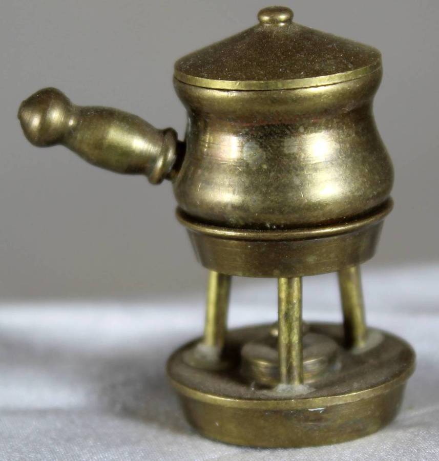 Miniature brass pot on gas burner