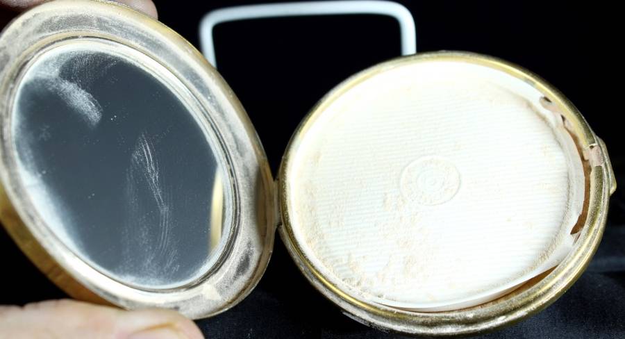 Embossed powder compact