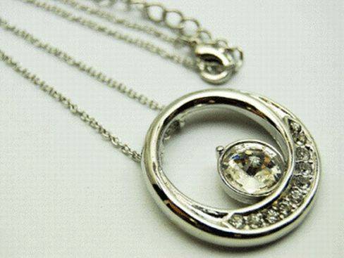 ROUND MOTIF PENDANT WITH LARGE CRYSTAL STUDS - ON LONG CHAIN