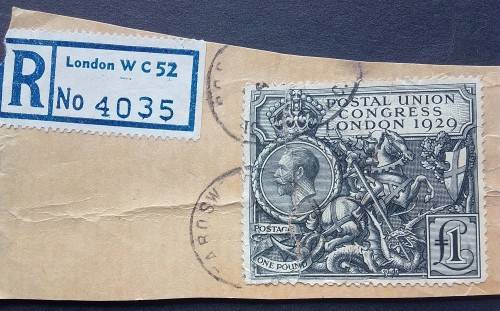 1929 Britain one pound King George V black used fixed to brown paper,creace on paper.small tear in s