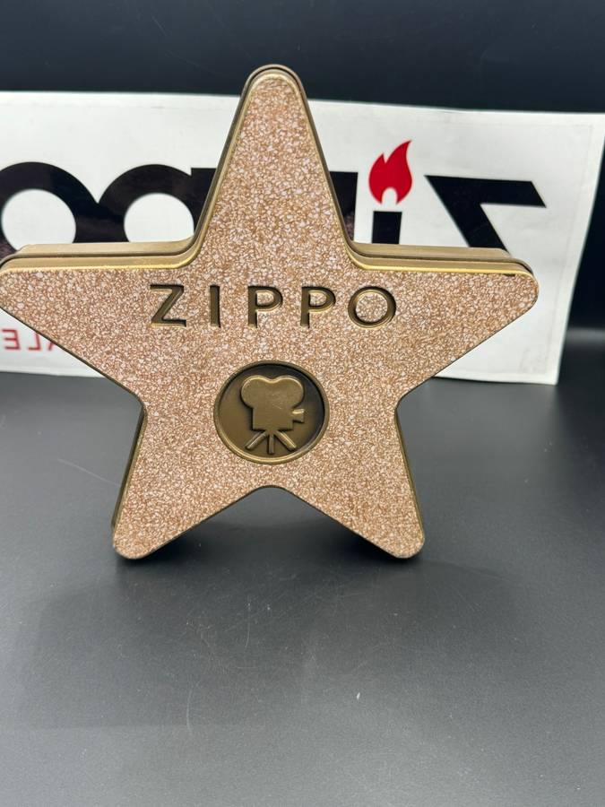 ZIPPO HOLLYWOOD'S LEADING LIGHT, A 2001 BRASS ZIPPO LIGHTER WITH APPLIED HOLLYWOOD STAR DESIGN