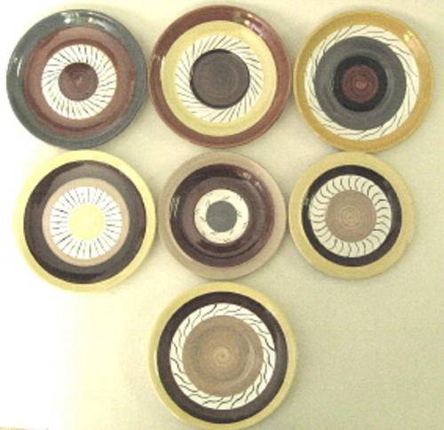 Seven saucers by Clementina van der Walt