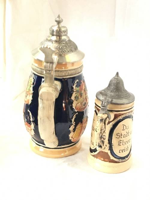 Set of 2 Graduating German Pottery Beer Steins Complete with pewter Lids.