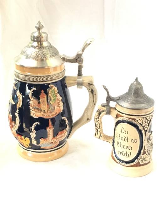 Set of 2 Graduating German Pottery Beer Steins Complete with pewter Lids.