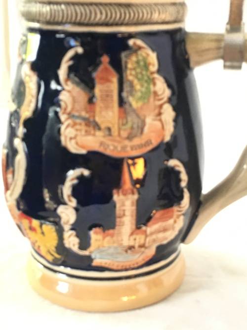 Set of 2 Graduating German Pottery Beer Steins Complete with pewter Lids.