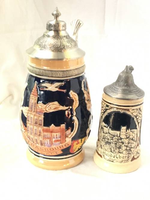 Set of 2 Graduating German Pottery Beer Steins Complete with pewter Lids.