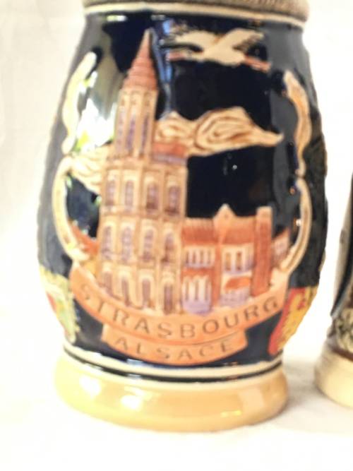 Set of 2 Graduating German Pottery Beer Steins Complete with pewter Lids.