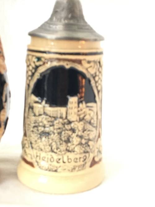 Set of 2 Graduating German Pottery Beer Steins Complete with pewter Lids.