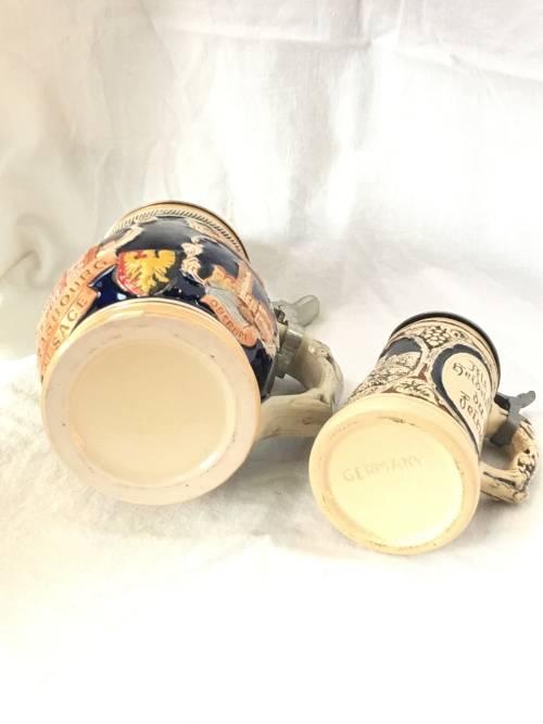 Set of 2 Graduating German Pottery Beer Steins Complete with pewter Lids.