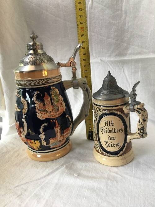 Set of 2 Graduating German Pottery Beer Steins Complete with pewter Lids.