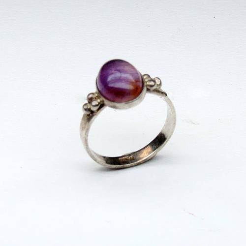 Silver ring with purple stone in
