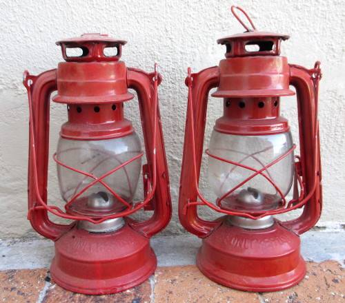 Two Red Parafin Lamps. 23cm high. As per photo