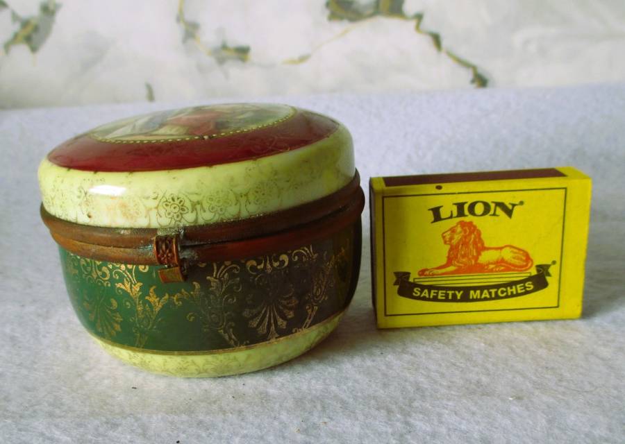 German Porcelain Round Trinket Box with hand painted gilt, brass hinge and rim. Pastoral Scene.