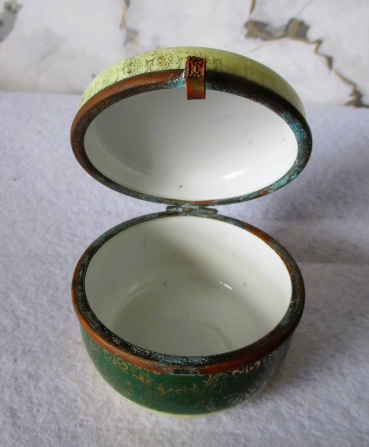 German Porcelain Round Trinket Box with hand painted gilt, brass hinge and rim. Pastoral Scene.