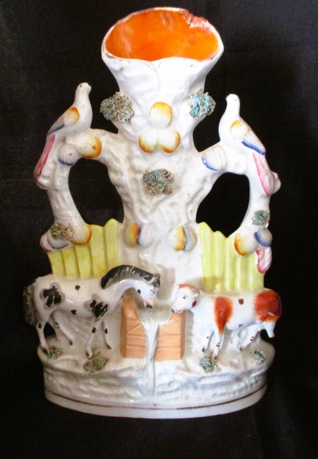 A Victorian Staffordshire spill, a cow and horse drinking from a trough beneath birds. Chip. 25x16cm