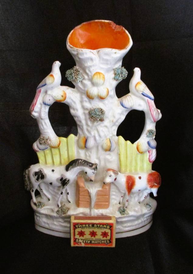 A Victorian Staffordshire spill, a cow and horse drinking from a trough beneath birds. Chip. 25x16cm