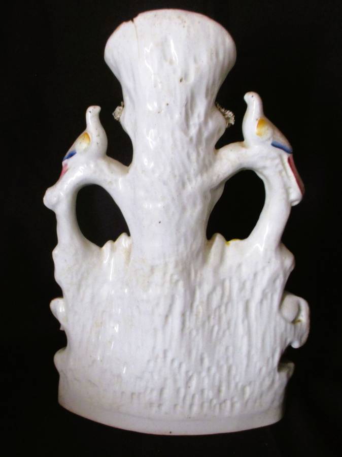 A Victorian Staffordshire spill, a cow and horse drinking from a trough beneath birds. Chip. 25x16cm