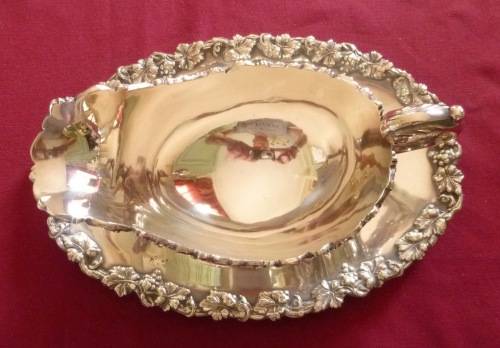 Dramatic silver plated sauce boat on stand