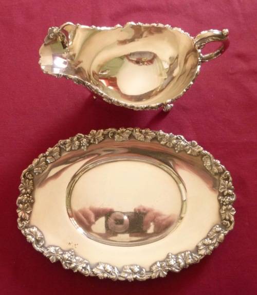 Dramatic silver plated sauce boat on stand