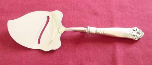 Silver handled cheese slice