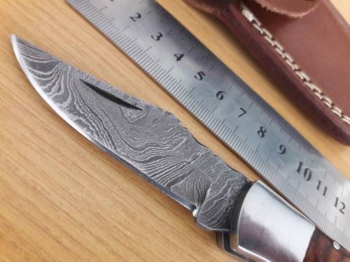 Handmade Damascus steel folding knife with Wooden handle scales.