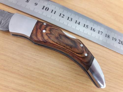 Handmade Damascus steel folding knife with Wooden handle scales.