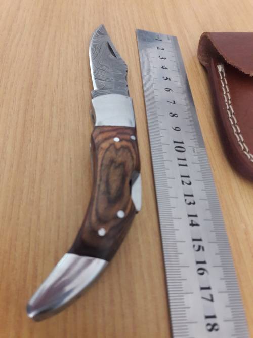 Handmade Damascus steel folding knife with Wooden handle scales.