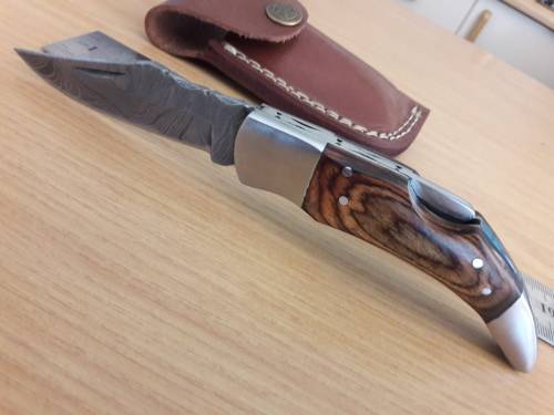 Handmade Damascus steel folding knife with Wooden handle scales.