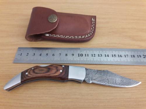 Handmade Damascus steel folding knife with Wooden handle scales.