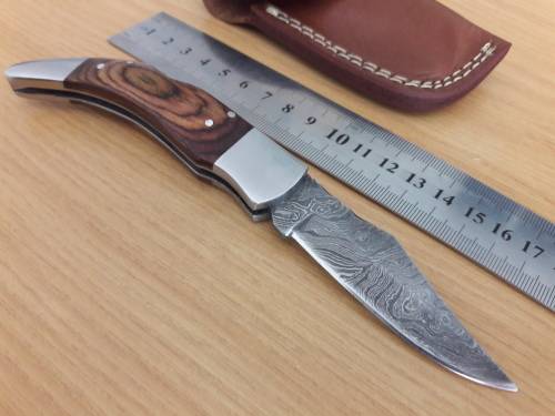 Handmade Damascus steel folding knife with Wooden handle scales.