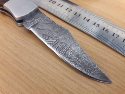 Handmade Damascus steel folding knife with Wooden handle scales.