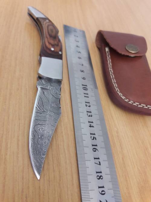 Handmade Damascus steel folding knife with Wooden handle scales.