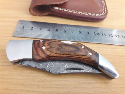Handmade Damascus steel folding knife with Wooden handle scales.
