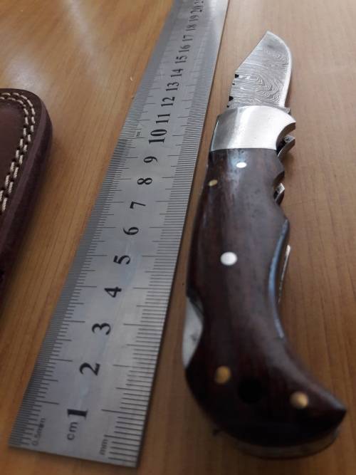 Handmade Damascus steel folding knife with Wooden handle scales.